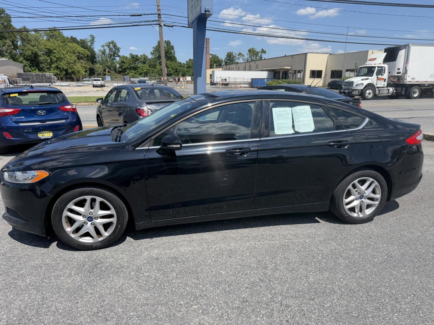 2016 BLACK Ford Fusion SE (3FA6P0HDXGR) with an 1.5L L4 DOHC 16V engine, 6A transmission, located at 1254 Manheim Pike, Lancaster, PA, 17601, (717) 393-9133, 40.062870, -76.323273 - Stylish, comfortable, and ready to go! The 2016 Ford Fusion SE offers a smooth ride, a roomy interior, and sharp styling that still looks great today. Whether you’re commuting to work or heading out for the weekend, this midsize sedan delivers comfort, practicality, and value. Bad credit or no- Photo#1