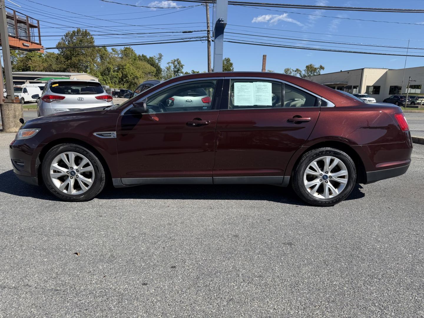 2012 MAROON Ford Taurus SEL FWD (1FAHP2EWXCG) with an 3.5L V6 DOHC 24V engine, 6-Speed Automatic transmission, located at 1254 Manheim Pike, Lancaster, PA, 17601, (717) 393-9133, 40.062870, -76.323273 - Enjoy comfort and style in this 2012 Ford Taurus SEL FWD! With a spacious interior and generous trunk space, this sedan is a practical choice for your daily commute, family outings, and weekend trips. Visit Ticket To Ride Auto Sales in Lancaster to take a closer look and explore financing options fo- Photo#1